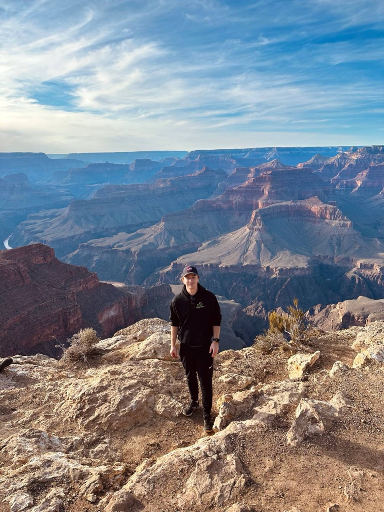 Kobey standing on the rim of the Grand Canyon